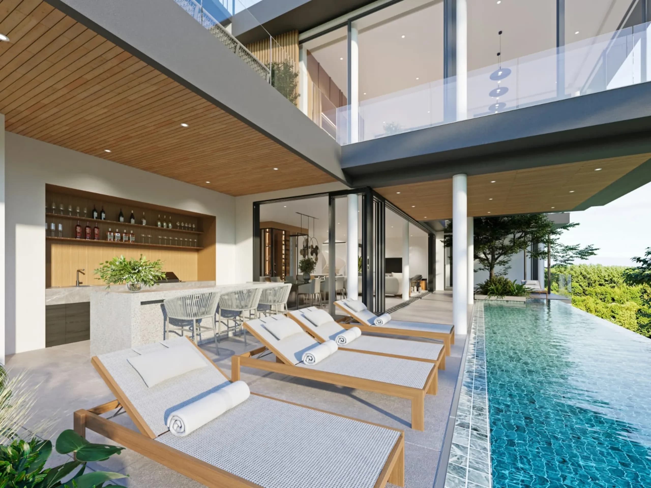 Pool deck with sun loungers and outdoor bar overlooking the infinity pool